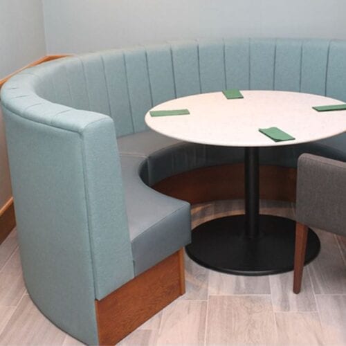 Circular Banquette seating with table and napkins