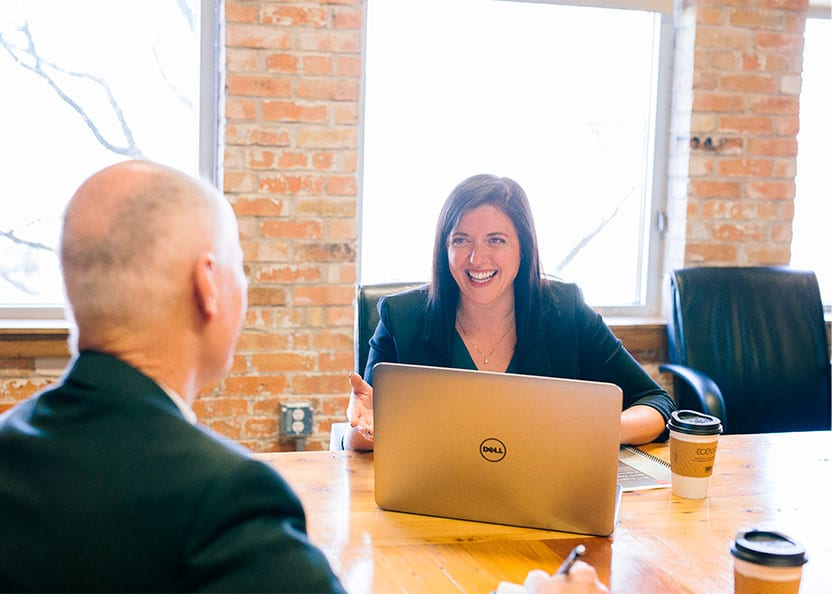 friendly sales manager with laptop and coffee